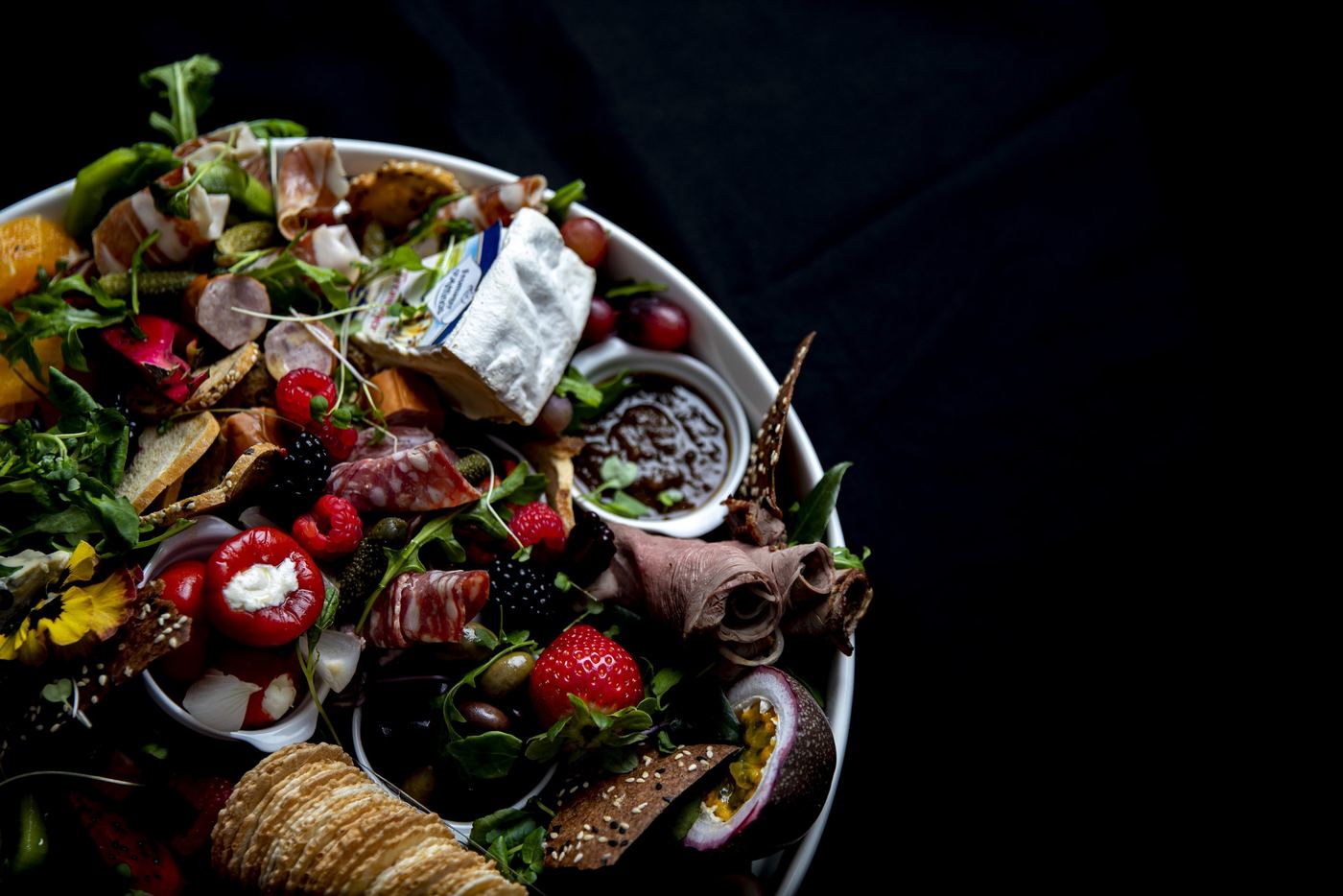 Abundant Chatham grazing platter with cheeses, cured meats, fruit and dips